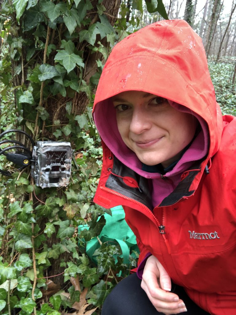 wildlife biologist with camera trap