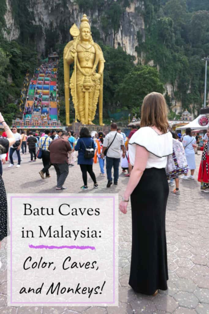 A picture of a woman looking at a giant statue