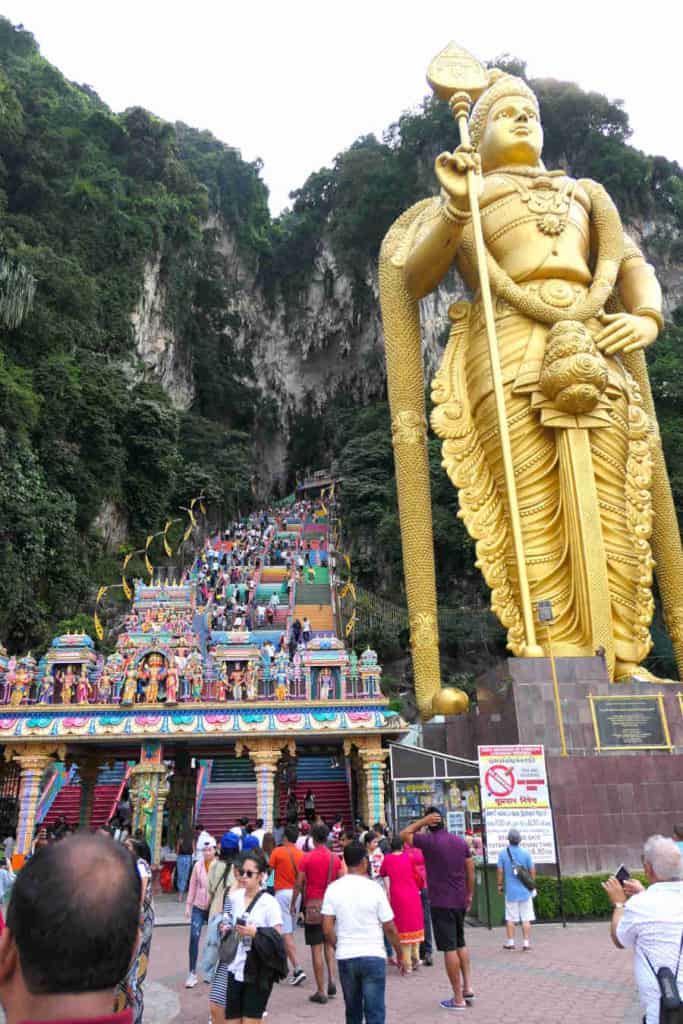A picture of tourists climbing the staircase to Batu Caves