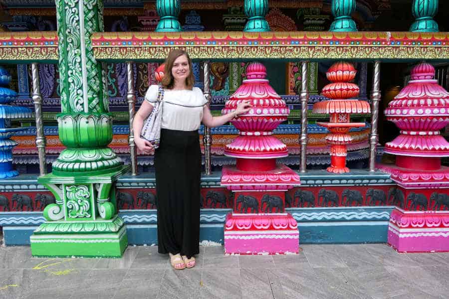A picture of a woman near the colorful columns