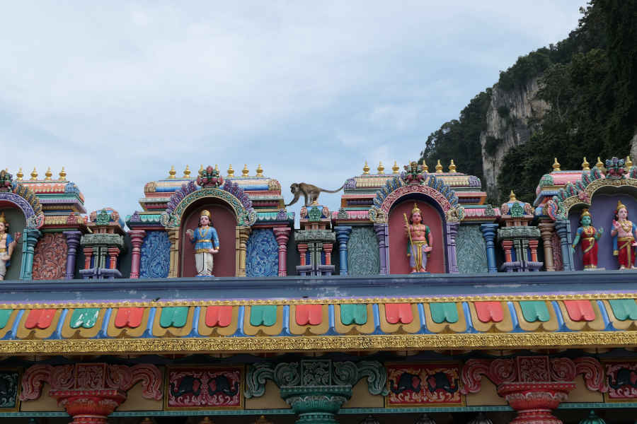 A macaque traversing the temple rooftop