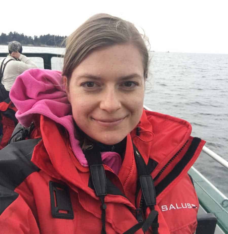 A picture of a woman in a boat taking a selfie.